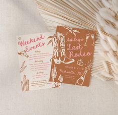 the wedding stationery is laid out next to some dried grass