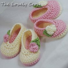 three crocheted baby shoes with flowers on them