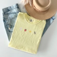 Welcome the sunny days with our Sunkissed Strawberry and Bee Embroidered T-Shirt! Made from 100% cotton Soft Comfort Colors, this shirt is both stylish and comfortable, perfect for your summer adventures.Features:Material: 100% cotton Soft Comfort ColorsSizes: S, M, L, XL, 2XL (refer to size chart in images)Colors Available: Banana, Bay, Blossom, Chalky Mint, Chambray, Ivory, Orchid, Peachy, Violet (Note: Colors may vary slightly due to monitor settings)Design: Summer-inspired embroidery featuring a daisy, strawberry, sun, and bee on the center chestCare Instructions: Machine wash cold, tumble dry lowThis Sunlissed Strawberry and Bee Embroidered T-Shirt is a delightful addition to your wardrobe, bringing a touch of sunshine wherever you go. Perfect for picnics, beach days, or casual outing Casual Summer T-shirt With Embroidered Graphics, Summer Crew Neck T-shirt With Floral Embroidery, Summer Floral Embroidered Crew Neck T-shirt, Casual Yellow Tops With Embroidered Graphics, Casual Yellow T-shirt With Embroidered Graphics, Cute Spring Tops In Organic Cotton, Cute Embroidered Relaxed Fit Tops, Cute Embroidered Tops With Relaxed Fit, Trendy Embroidered Summer T-shirt