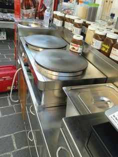 two pans are sitting on top of the counter in a kitchen with other items