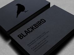 two black business cards with a bird on the front and back one is dark gray