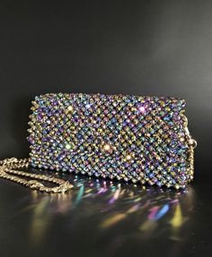 This stunning handmade crystal glass purse is a true statement piece for any occasion. It is made with crystal glass beads and crufted with meticulous attention to detail. This eye-catching handbag is perfect for special events, nights out, or as a luxurious everyday accessory. With included chain and a compact interior, this purse effortlessly blends functionality with glamour. Ideal for holding your essentials, it's a perfect blend of art and practicality. Make a bold fashion statement and shi Luxury Beaded Bag For Everyday Use, Glass Purse, Everyday Accessories, Bold Fashion, Clutch Handbag, Metal Chain, Crystal Glass, Evening Bags, Purses And Handbags