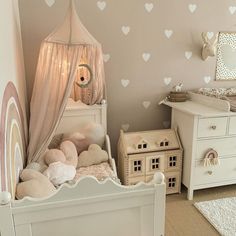 a child's bedroom decorated in pink and white with hearts painted on the walls