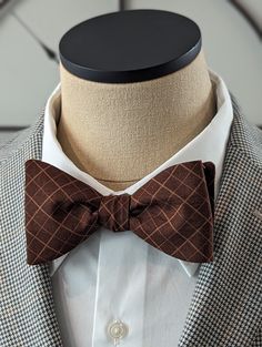 Elevate your style with this exquisite Brown Windowpane Bow Tie. Handcrafted with precision and attention to detail, this custom self-tie bow tie is the perfect accessory to add a touch of sophistication to your outfit. Featuring a classic stripe pattern, this bow tie is versatile and can be paired effortlessly with both casual and conservative attire. Whether you're attending a business meeting or a social event, this bow tie will instantly elevate your look and make a lasting impression. Made from high-quality materials, this Brown Windowpane Bow Tie is not only stylish but also durable, ensuring that it will last for years to come. The self-tie design allows for the perfect fit and gives you the freedom to adjust it according to your preference. With its timeless appeal, this bow tie is Classic Pre-tied Decorative Bow, Classic Bow Ties For Black-tie Events, Classic Pre-tied Tie With Decorative Bow, Classic Pre-tied Bow Tie, Classic Pre-tied Bow With Ties, Classic Pre-tied Bow, Dapper Satin Bow Tie, Classic Adjustable Bow For Business, Adjustable Classic Bow For Business