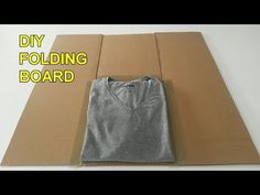 a cardboard box with a t - shirt on it and the words diy folding board