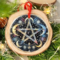 an ornament hanging from a christmas tree with stars and moon designs on it