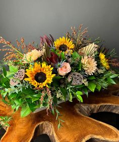 a bouquet of flowers sitting on top of a wooden table