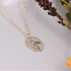 Birth Flower necklace with Lily of the Valley Flower for May birth month. This hand-drawn design on sterling silver keepsake jewelry is simple enough for everyday wear. This custom necklace is a perfect gift for Grandma, Mom or Daughter on her Birthday, for Christmas or Mother's Day. *Charm: 13mm by 18mm *Chain Selection: 16-24 inch *Handcrafted from sheet metal with secure connections *Satin finish .925 Sterling Silver, 14/20 Rose Gold Filled or 14/20 Yellow Gold Filled *Boxed in simple Kraft c Delicate Sterling Silver Birth Flower Charm Necklaces, Sterling Silver Birth Flower Jewelry For Birthday, Delicate Personalized Sterling Silver Flower Necklace, Birth Flower Oval Pendant Jewelry For Mom, Oval Pendant Jewelry With Birth Flower For Mom, Mother's Day Sterling Silver Flower Necklace For Mom, Mother's Day Sterling Silver Flower Necklace Gift For Mom, Delicate Sterling Silver Birth Flower Necklace, Mother's Day Flower Pendant Necklace In Sterling Silver