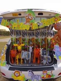 an animal themed vehicle is parked in the grass