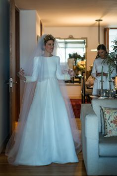 a woman in a wedding dress standing next to a man