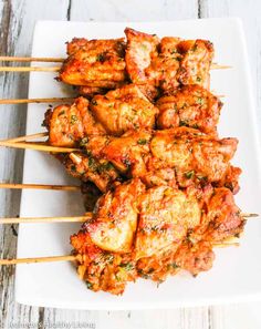 chicken skewers with marinara sauce on a white plate