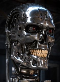 a silver robot with red eyes and teeth