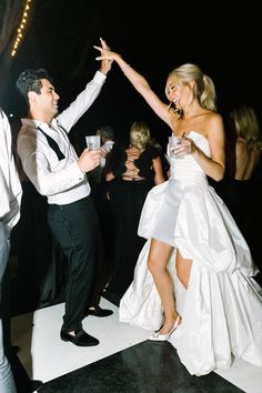 a man and woman are dancing on the dance floor