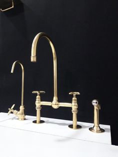 three faucets and two soap dispensers on display