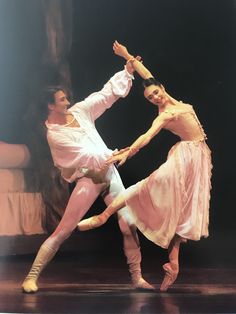 two ballerinas are performing on stage together