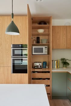 a kitchen with wooden cabinets and white counter tops