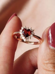 Wear your heart on your sleeve (or on your finger) with our garnet Bleeding Heart ring. A symbol for a deep love and compassion for everything in creation, the beautiful bleeding heart flower is one of our absolute favorites 🥀. Let the Bleeding Heart ring be a sparkling and precious reminder of the beauty in our softness and the love and compassion that connects us all. ❤️ Don't know your ring size? View our Ring Size Guide …………………………………. RING SIZE & MATERIAL❋ 14k rose gold plated sterling Fine Jewelry Red Heart Ring For Wedding, Red Heart Shaped Rings With Accent Stones, Garnet Heart Rings, Red Heart-shaped Rings With Accent Stones, Elegant Heart-shaped Ruby Ring For Valentine's Day, Heart On Your Sleeve, Love And Compassion, Garnet Heart, Garnet Crystal