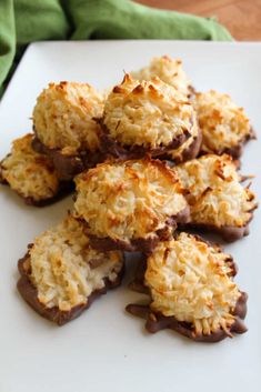 chocolate covered cookies on a white plate with green napkin