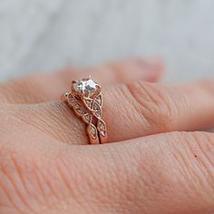 a woman's hand with a diamond ring on top of her finger and an engagement band