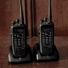 two old style walkie talkies sitting next to each other