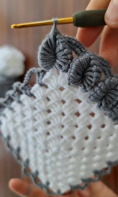 someone crocheting an object with yarn