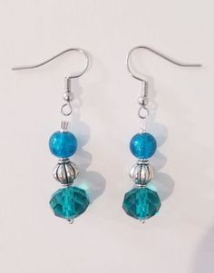 "\"AQUAMARINE DREAM\" earrings These turquoise & terrific earrings feature round turquoise glass beads, turquoise faceted glass beads, silver metal lantern beads, and silver seed beads. Approximate Measurements: Earring Length - 2 inches Earring Drop Length - 1.25 inches Earring Width - .5 inch *These earrings arrive in a handmade, hand-decorated box." Turquoise Czech Glass Beaded Earrings, Hypoallergenic Turquoise Beaded Earrings, Adjustable Turquoise Earrings With Faceted Beads, Turquoise Czech Glass Dangling Beads Earrings, Turquoise Czech Glass Earrings With Dangling Beads, Turquoise Czech Glass Dangling Earrings, Turquoise Beaded Earrings With Faceted Round Beads, Turquoise Czech Glass Round Bead Earrings, Turquoise Round Faceted Beaded Earrings