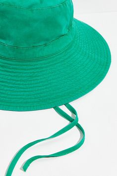 Perfect for outdoor adventures, this so classic bucket hat features a wide, floppy brim in a washed design and straps that tie under the chin. * Unstructured style * Adjustable fit | Lake Washed Bucket Hat by RAHI at Free People in Green Green Sun Hat With Upf 50+ And Adjustable Fit, Adjustable Bucket Sun Hat For Spring, Spring Adjustable Bucket Sun Hat, Spring Wide Brim Bucket Hat With Adjustable Fit, Green Adjustable Fit Bucket Sun Hat, Adjustable Fit Green Brimmed Sun Hat, Green Curved Brim Bucket Hat For Travel, Green Adjustable Sun Hat With Curved Brim, Green Wide Brim Bucket Hat For Outdoor Activities