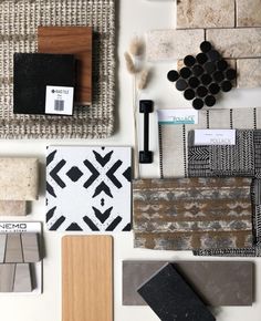 various types of tiles and flooring laid out on top of a white countertop