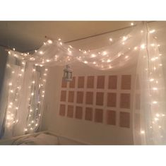 a bedroom with lights strung from the ceiling