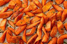 roasted carrots with herbs and seasoning on a baking sheet