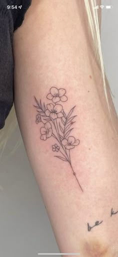 a woman's arm with a flower tattoo on the left side of her body