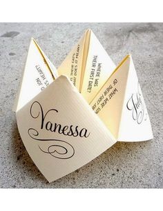 an origami fortune card holder with the word's name written on it