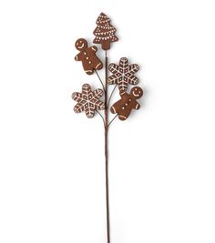 a tall metal tree with gingerbread cookies on it's top and leaves in the shape of snowflakes