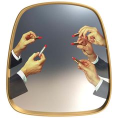 several hands holding pens and pointing at them in front of a mirror with the reflection of another person's hand