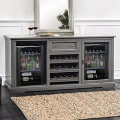 an entertainment center with two wine coolers and a mirror