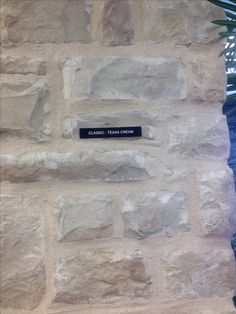 a brick wall with a plaque on it