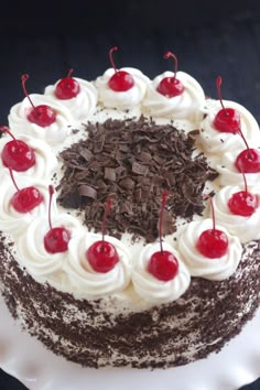 a black forest cake with cherries and chocolate shavings on the top is ready to be eaten