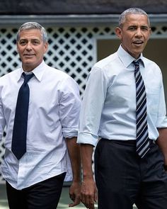 two men in ties standing next to each other