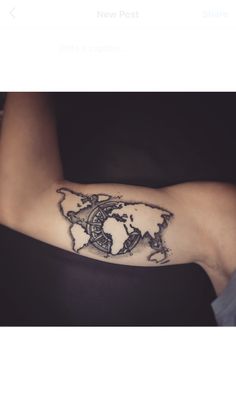 a person with a tattoo on their arm that has a world map in the middle