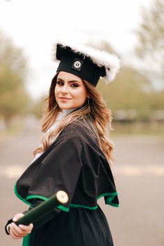 a woman dressed in a costume and holding a baseball bat is posing for the camera