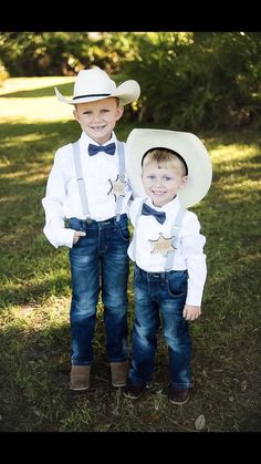 two young boys wearing cowboy hats and suspenders