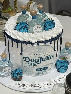 a birthday cake made to look like a bottle of donjitto with blue icing