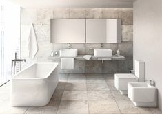 a white bathroom with two sinks, a bathtub and a toilet next to each other