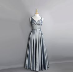 A stunning evening gown or ball gown made from a beautiful shot taffeta in silver/grey. The bodice features our ultra flattering wide fitted waistband and romantic sweetheart neckline and the dress has a generous full length, full circle skirt. The dress is shown in a sleeveless style but it can also be made with cap, elbow or 3/4 length sleeves - please message us for more info.  In the last two photos the dress is shown with our beautiful sequin lace bolero which is not included in the sale bu Silver Sleeveless Satin Evening Dress, Sleeveless Silver Satin Evening Dress, Silver Satin Sleeveless Evening Dress, Metallic Satin Evening Dress For Formal Occasions, Metallic Satin Evening Dress For Gala, Metallic Satin Formal Evening Dress, Formal Floor-length Silver Ball Gown, Elegant Silver Ball Gown For Party, Silver Satin Evening Dress