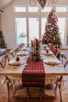 a dining room table set for christmas dinner