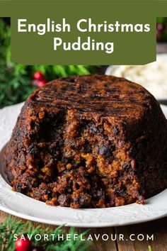 a close up of a cake on a plate with the words english christmas pudding above it