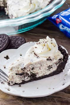 a slice of ice cream pie on a plate with oreo cookies in the background