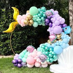 a number made out of balloons in the shape of mermaids and seashells