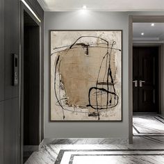 an abstract painting hangs on the wall next to a hallway with marble floors and gray walls