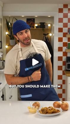 a man holding an apron over a plate of food on top of a kitchen counter